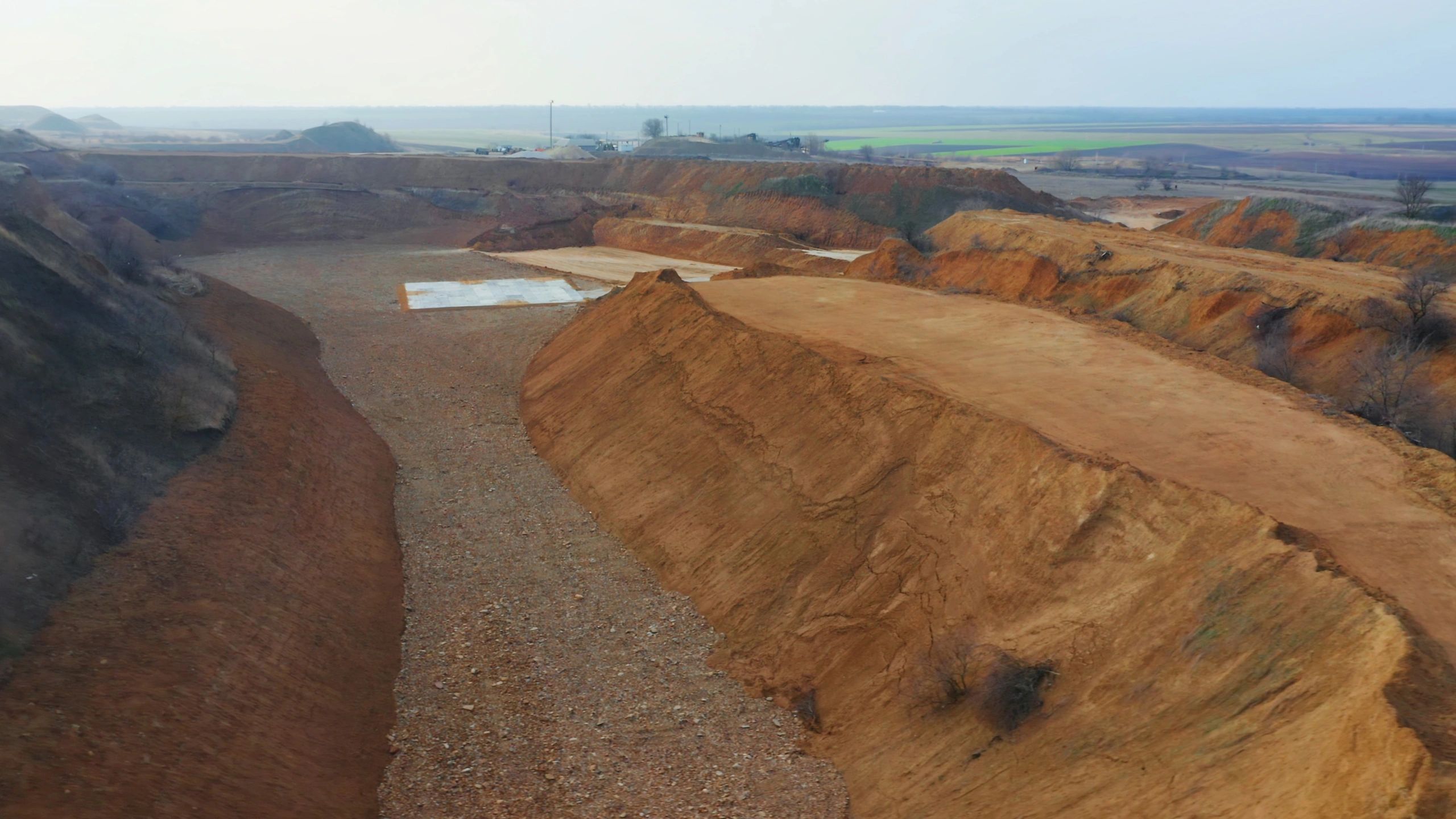 Industrial landscape with material stockpiles and haul roads